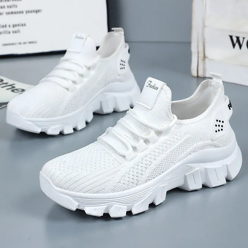 Men's white Flyknit tennis shoes with thick PVC sole and lace-up front