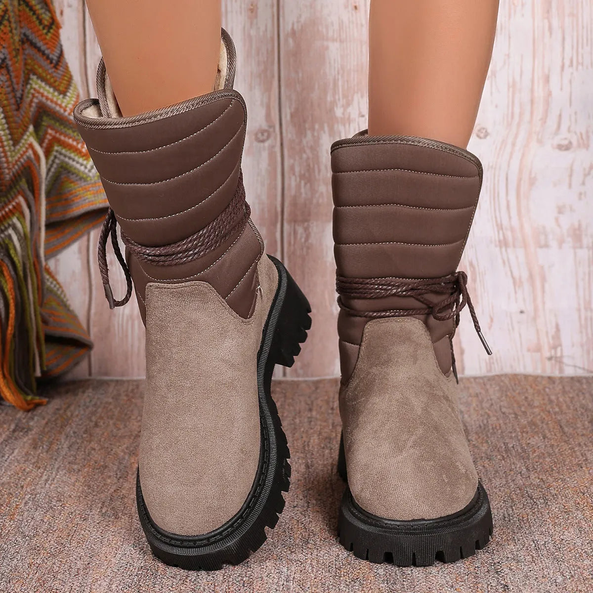 Women's black suede snow boots with chunky heel, lace-up design, and fleece lining on a white background.