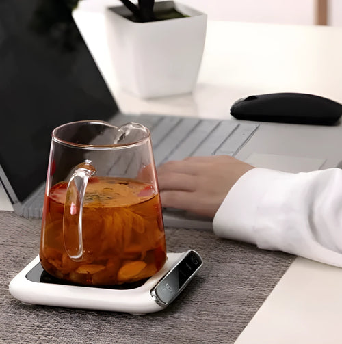 Black USB cup warmer with temperature controls and reminder light on desk