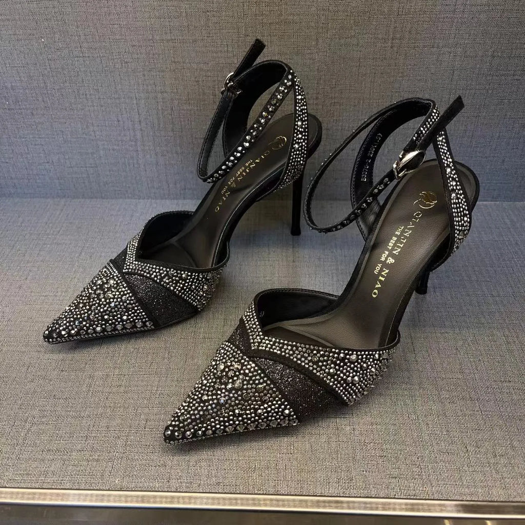 Women's black high heels with hollow red stiletto heel and pointed toe.