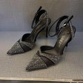 Women's black high heels with hollow red stiletto heel and pointed toe.