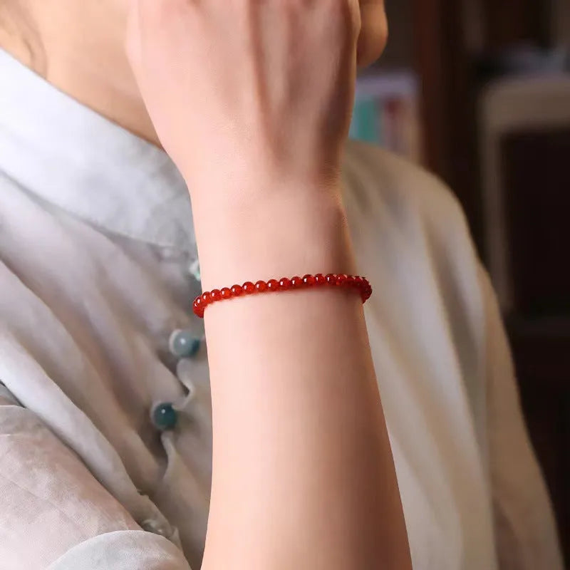 Ultra-thin classic red agate bracelet for women on a white background.