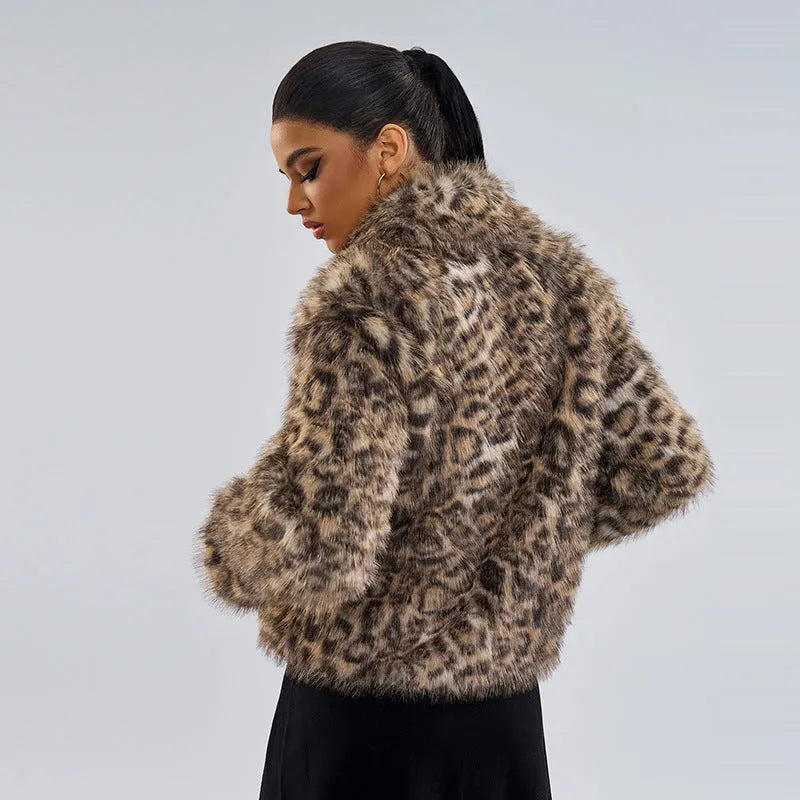 Women's leopard print coat with a buckle lapel closure on a hanger.