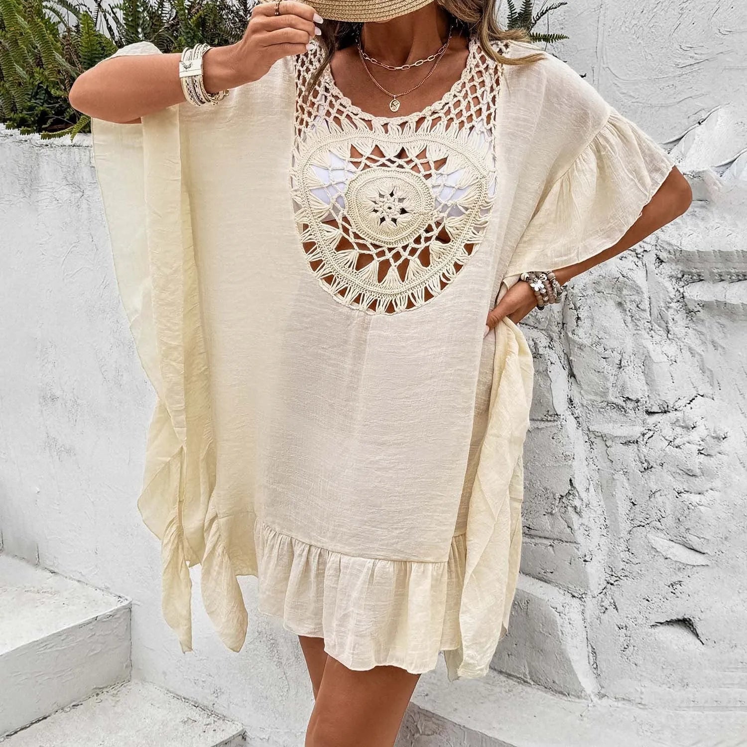 Crochet stitching detail on tassel-trim patchwork skirt beach cover-up dress in apricot colour.