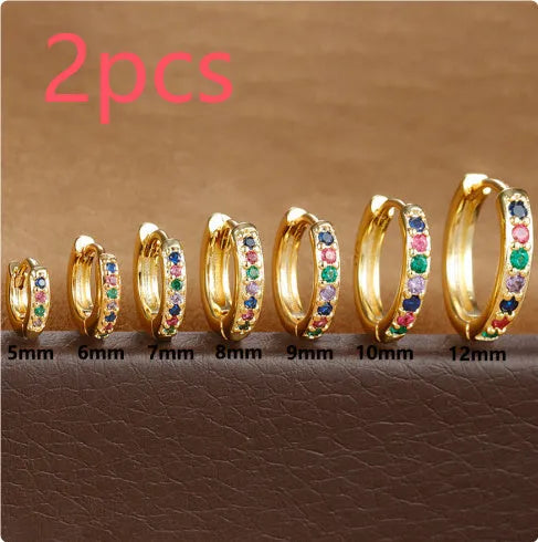 Circle-shaped cubic zirconia stud earrings in gold, rose gold, and silver colours on a white background.