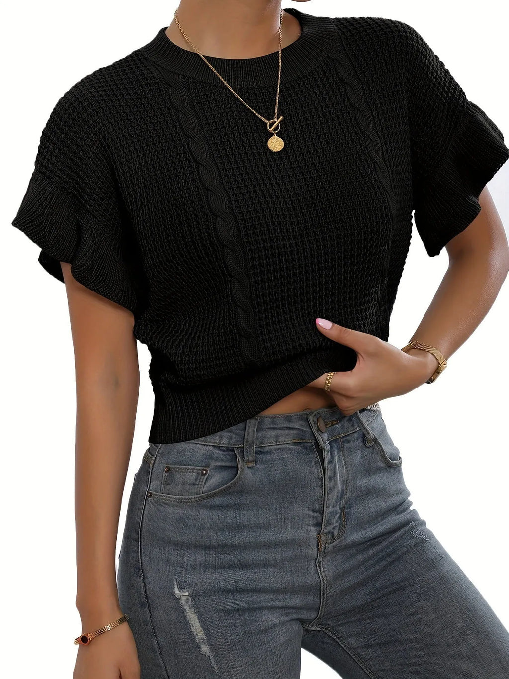 White twisted string knitted pullover sweater with ruffled short sleeves on a hanger.