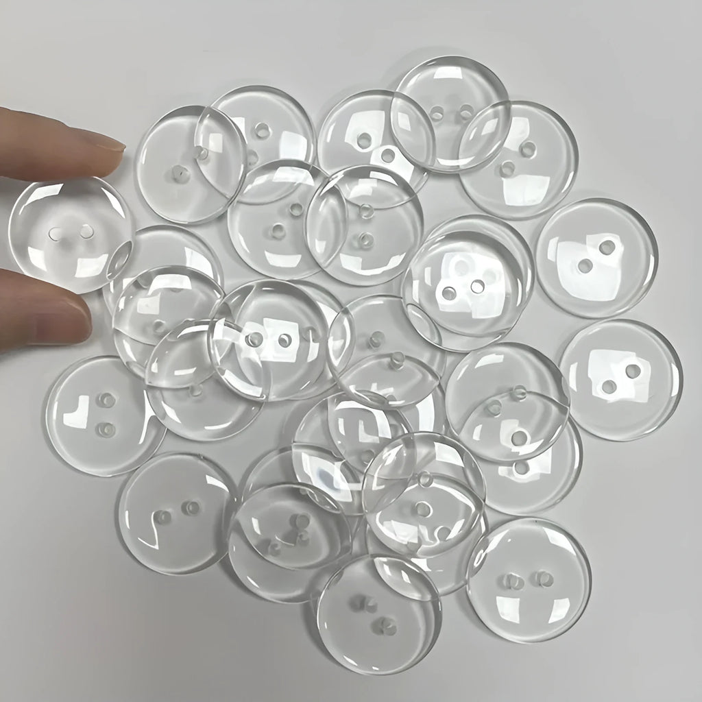 Transparent two-eye resin button 10mm on white background
