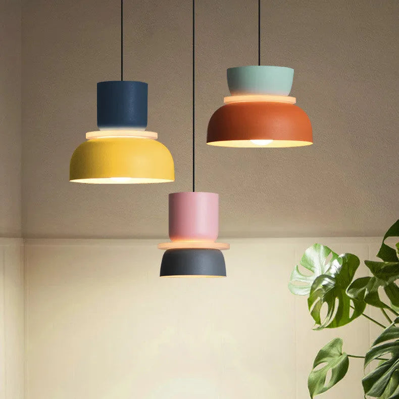 Nordic minimalist iron pendant light in a dark colour with a warm light bulb for bedroom or cafe use