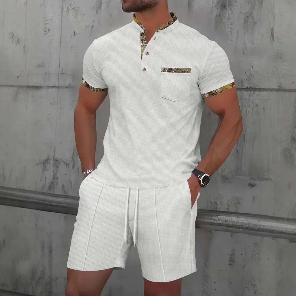 Man modelling a grey zip-front polo collar top and matching shorts, a waffle knit leisure suit set.