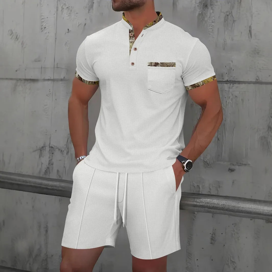 Man modelling a grey zip-front polo collar top and matching shorts, a waffle knit leisure suit set.