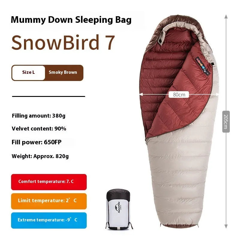 Adult mummy-style sleeping bag with goose down filling shown with its storage bag.