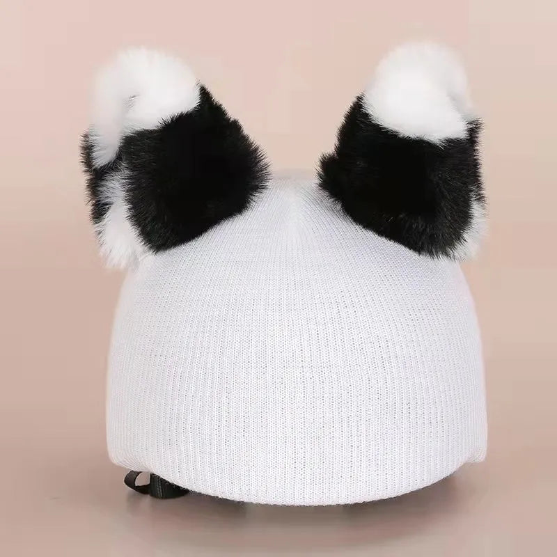 Soft plush cartoon character cover stretched over a pair of black on-ear headphones.