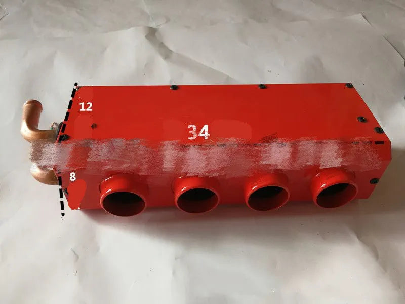 Long metal car heater unit with four copper pipe connectors for engine coolant.