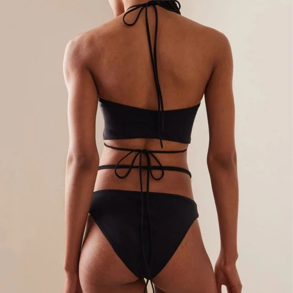 Black women's lace-up bikini swimsuit with separate bra and shorts pieces on mannequin