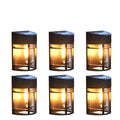 Set of 6 solar-powered outdoor wall lights with warm white illumination mounted on a garden wall