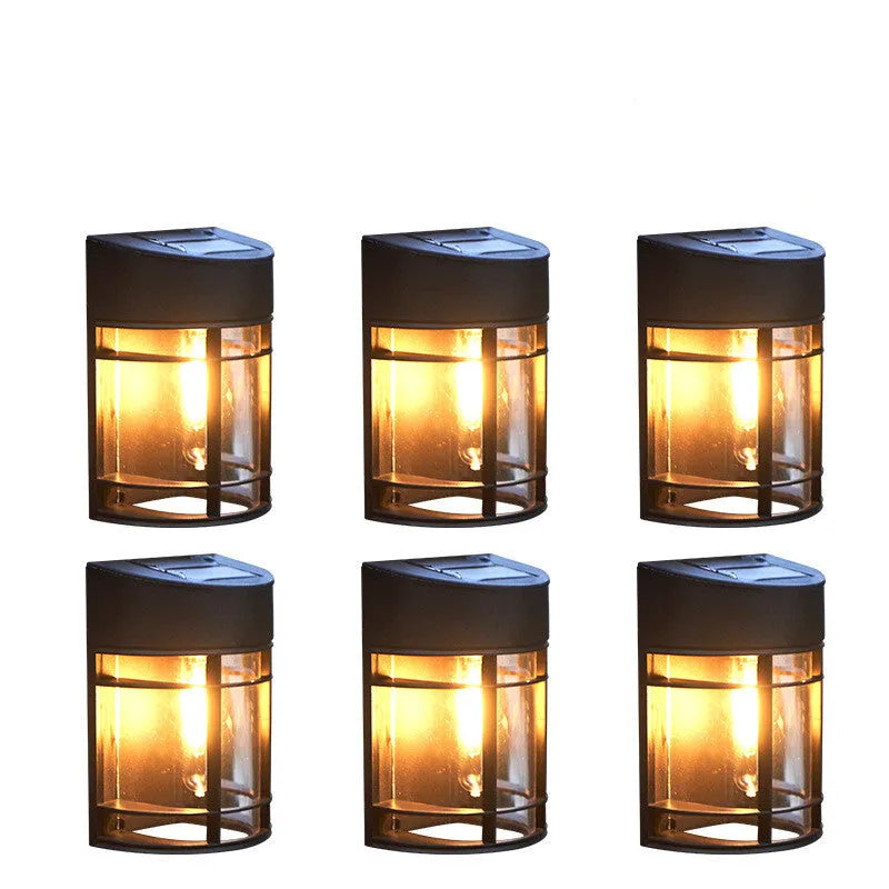 Set of 6 solar-powered outdoor wall lights with warm white illumination mounted on a garden wall