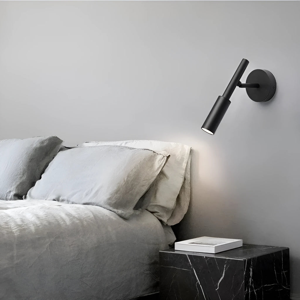 Black and white modern wrought iron wall lamp with a compact shade.