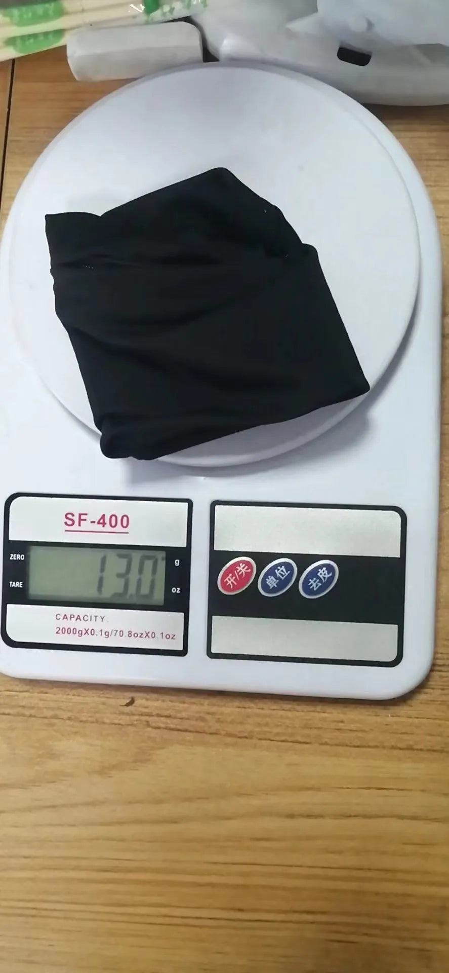Black wrist sleeve bag with a mobile phone inserted, showing hands-free design on a person's wrist.