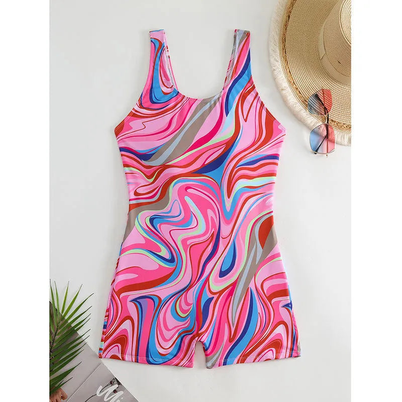 Close-up of a woman's printed high-waist backless one-piece swimsuit in a blue pattern, showing the polyester fabric texture and fit.