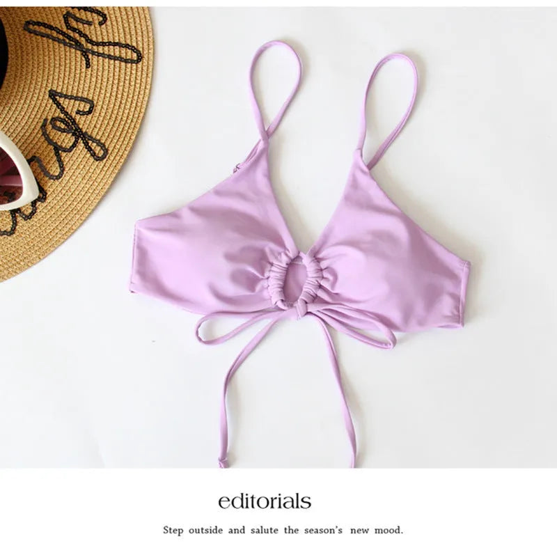 Women's pure colour tied bow split swimsuit bikini on a hanger, showing brief cut.