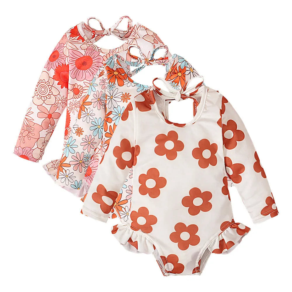 Girls floral print swimsuit with crew neck front and open back in orange colour