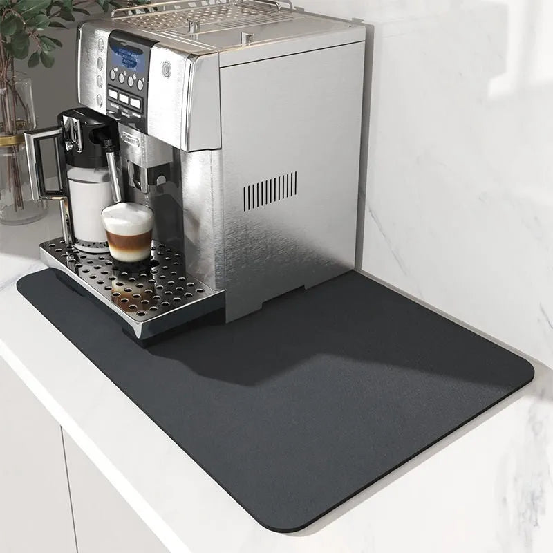 Square kitchen drain pad mat with black PU leather surface showing liquid absorption and rubber anti-slip backing