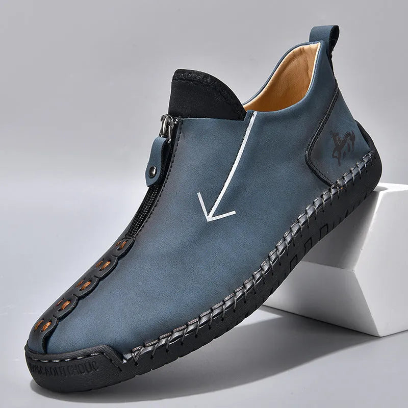 Men's black leather ankle boots with a front zip and round toe on a rubber sole