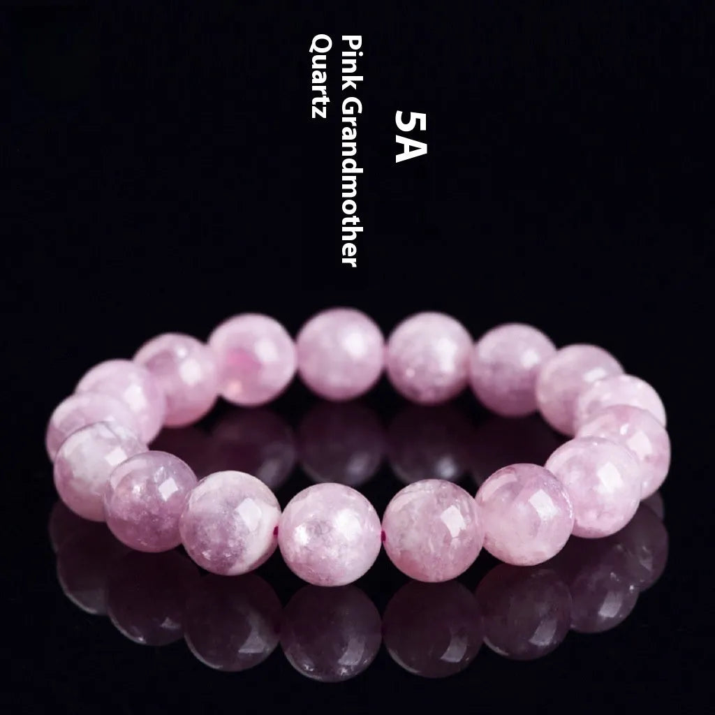 Grandmother crystal bracelet with polished purple geometry beads on a white background.