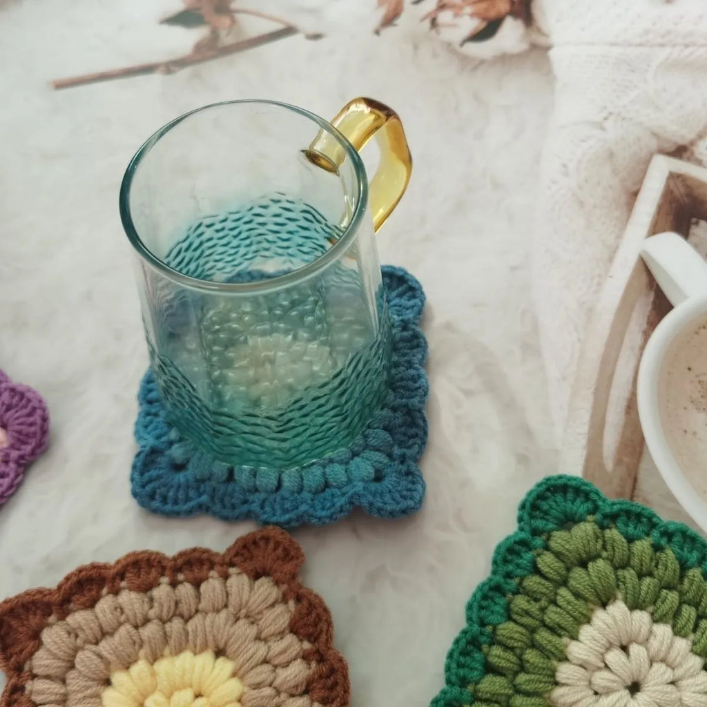 Crocheted wool insulated cup placemat with grandmother lattice pattern in choice of colours