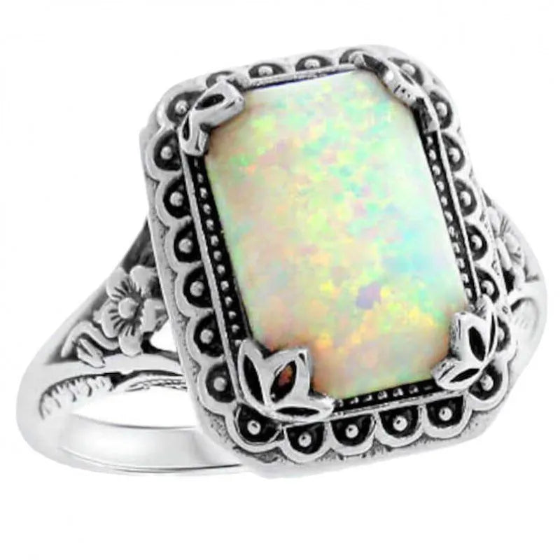 Silver alloy geometric ring with inlaid opal stone on a white background