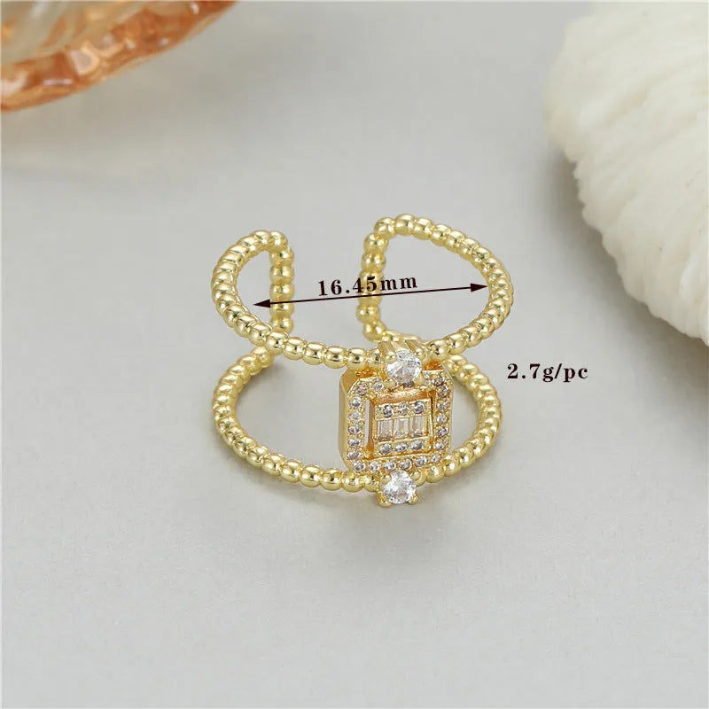Gold-coloured asymmetric U-shaped open ring with an adjustable gap on a plain background.