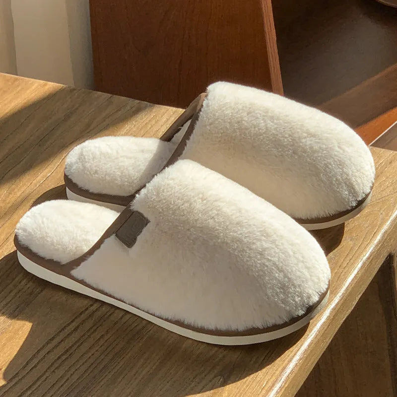 Pair of solid colour plush house slippers with a non-slip PVC sole, shown in coffee brown.