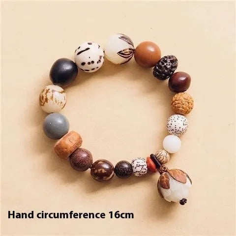 Handmade brown Bodhi seed bead bracelet with geometric design on a 16cm wrist.