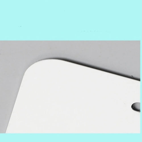 White aluminium licence plate sheet measuring 30.3 by 15 centimetres