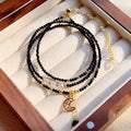 Blue gold sand stone three-ring multi-layer bracelet for women on a white background.
