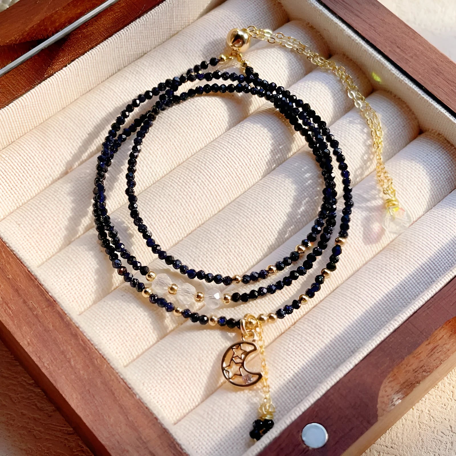 Blue gold sand stone three-ring multi-layer bracelet for women on a white background.
