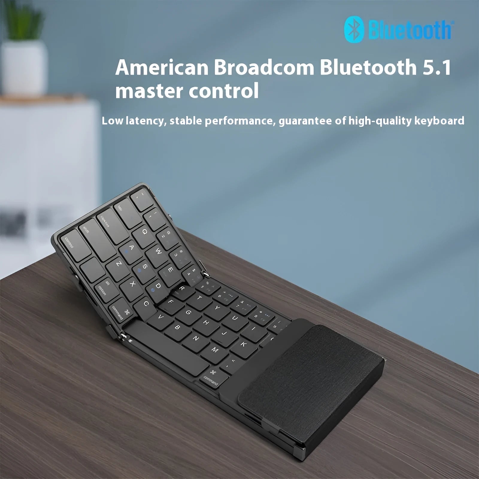 Black folding Bluetooth keyboard for mobile phones and tablets shown in open and closed positions