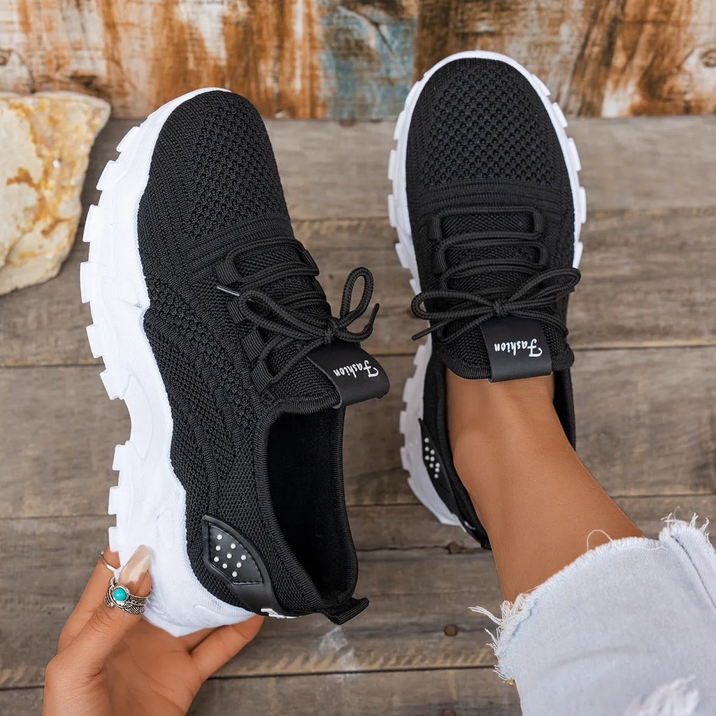 Women's white Flyknit mesh sports casual shoes with flat heel and lace-up front.