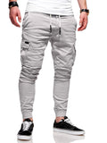 Men's loose light blue casual trousers with patch pockets and elasticated waistband on a neutral background.