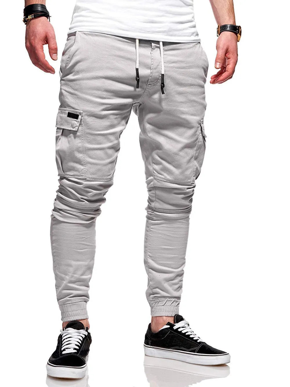 Men's loose light blue casual trousers with patch pockets and elasticated waistband on a neutral background.