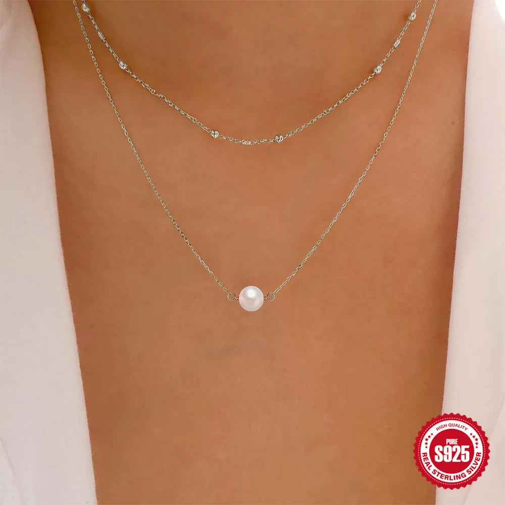 S925 sterling silver double layer pearl necklace with geometric pendant on a ball bead chain.
