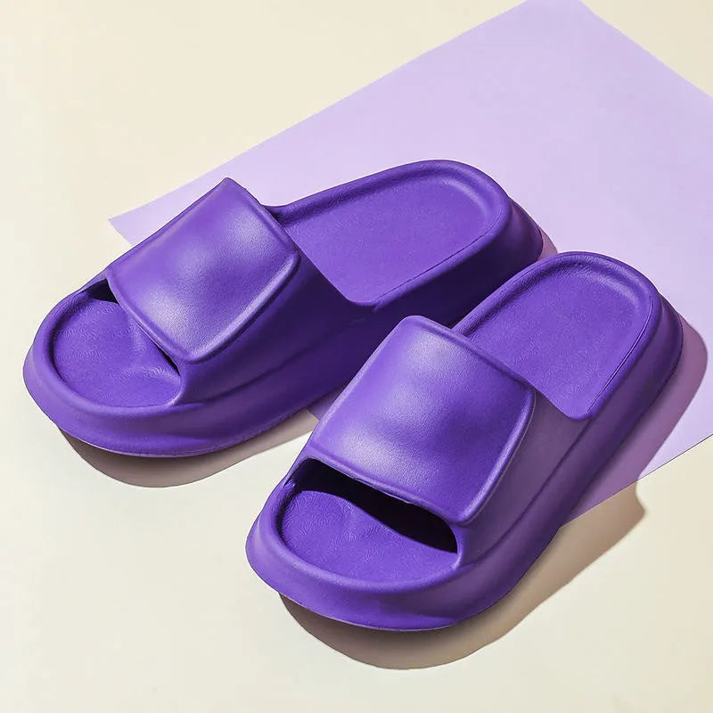 Pair of thick-soled white EVA flip-flop slippers with a non-slip patterned sole.