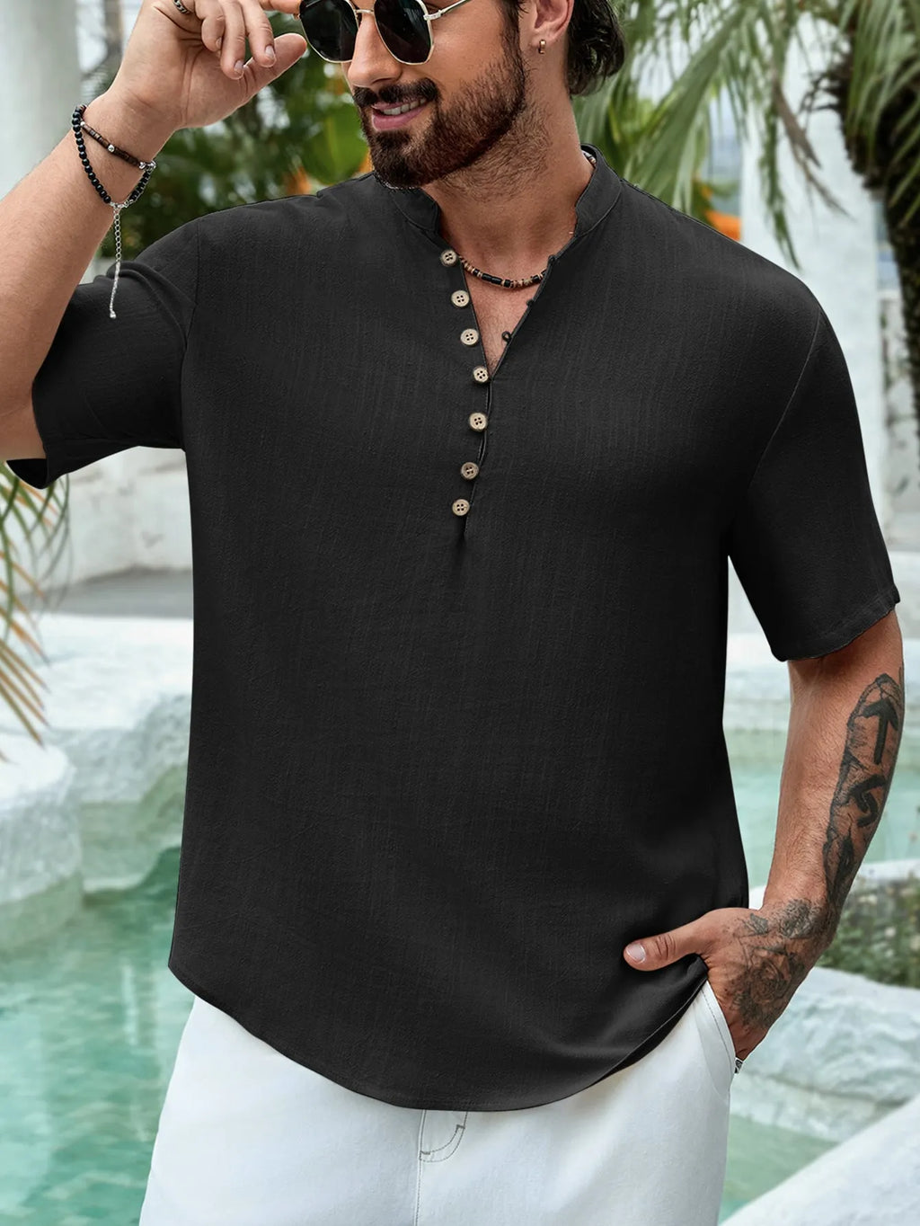 Man wearing a deep V-neck multi-button short sleeve casual shirt in a solid colour.