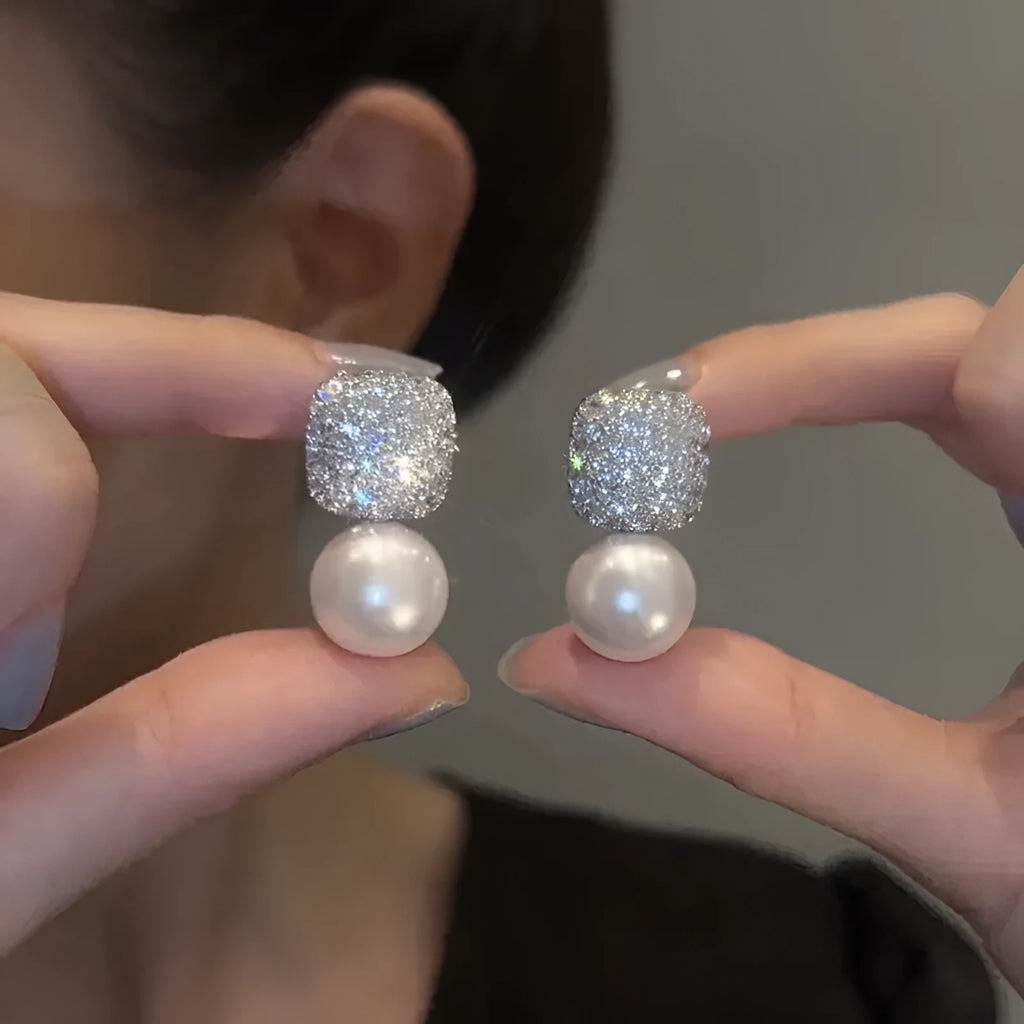 Micro inlaid zircon square pearl stud earrings with tassel detail in copper and imitation pearl, available in three colours: champagne, red, white.