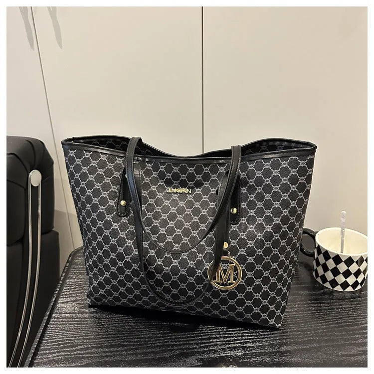 PU leather shoulder bag with adjustable strap in black, shown with visible stitching detail.