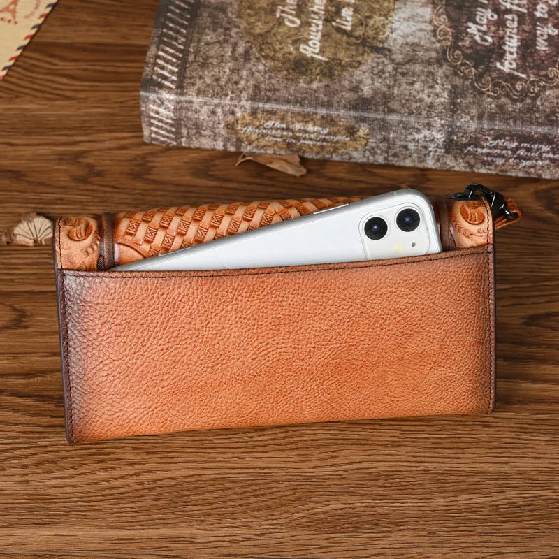 Brown tri-fold leather wallet with deep embossed floral pattern, shown open to reveal card slots and lining.