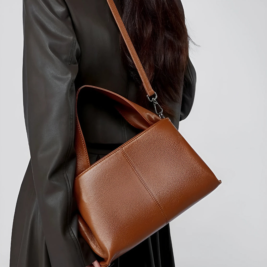 Women's genuine cowhide messenger bag with retro texture in horizontal square design showing shoulder straps and exterior pocket