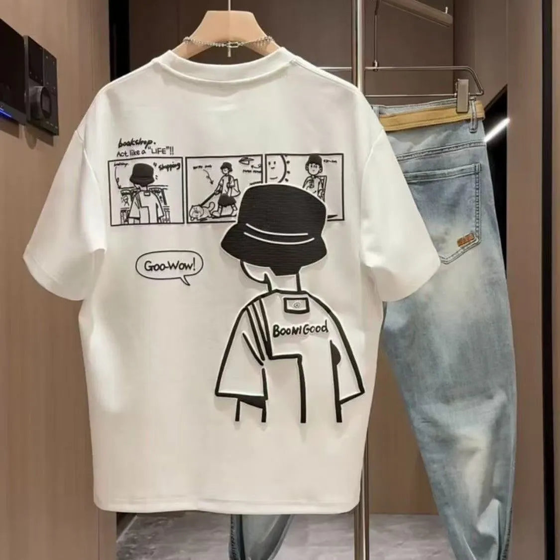 Man wearing a black slim fit pure cotton t-shirt with a simple cartoon print design on the front.