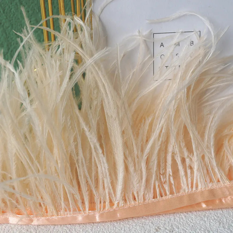 Decorative feather cloth strip in multiple colours including white, black, and mint green for DIY clothing and craft projects