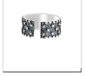Adjustable sterling silver ring showing multiple five-pointed star geometric pattern on band